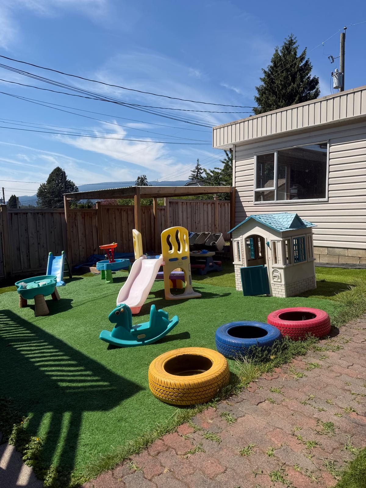 Spring Childcare outdoor play area with slides and toys